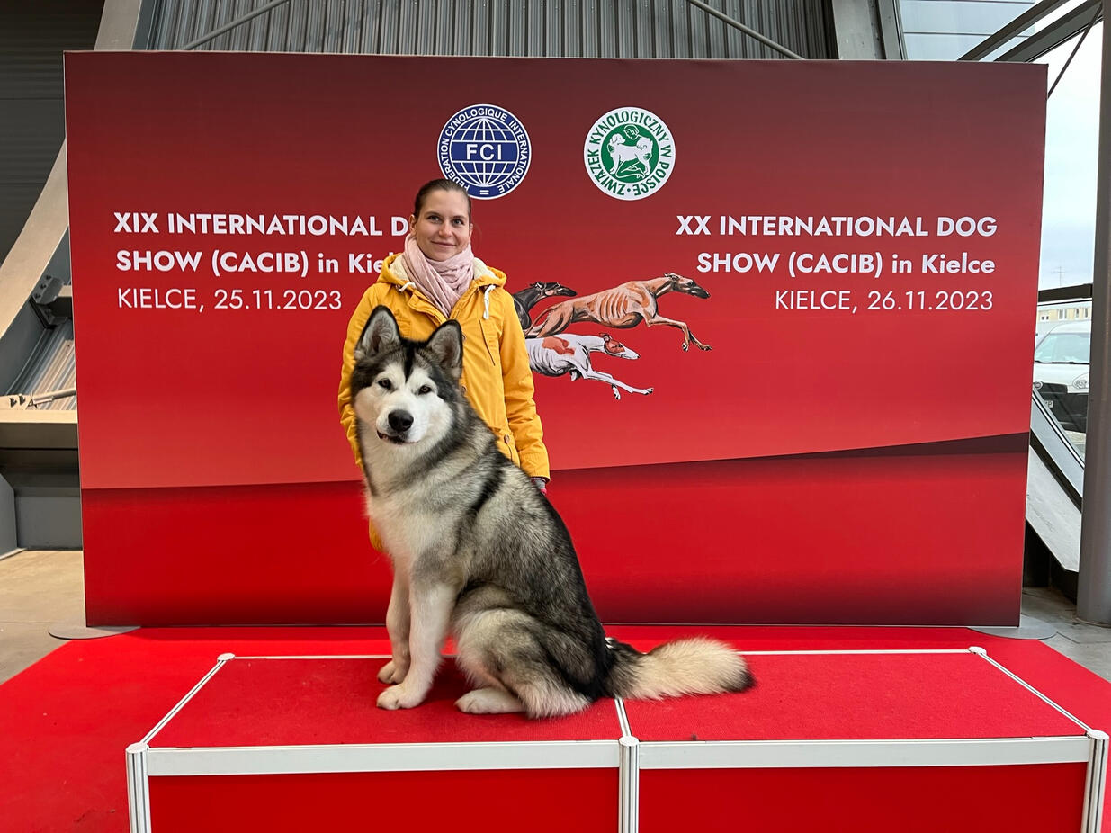 Aurora proudly holding her CACIB trophy at the XX International Dog Show 2023.